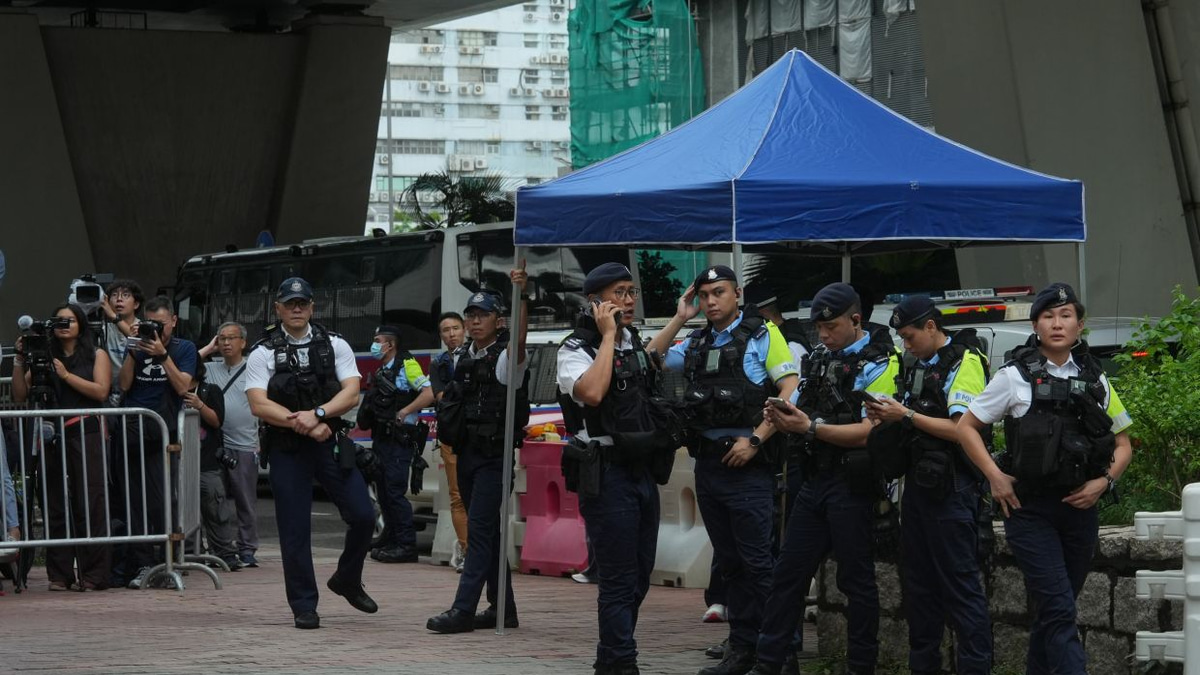 Hong Kong woman arrested for seditious T-shirt outside court as democracy leaders convicted