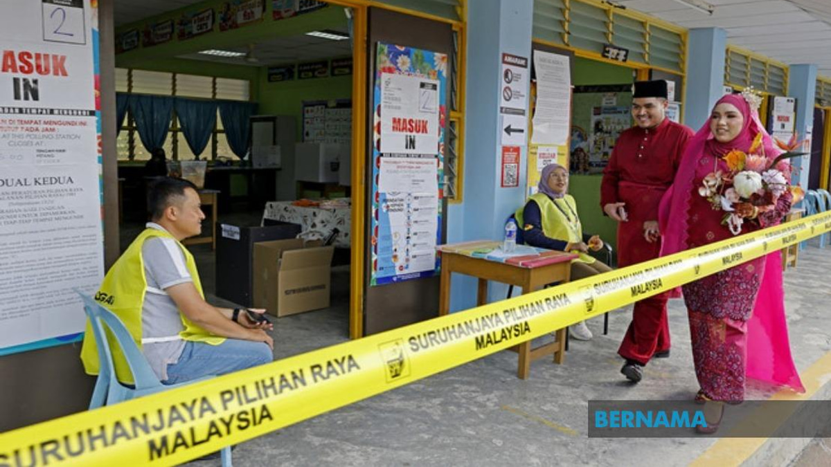 Young Bride Casts Vote in Traditional Wedding Dress at Negeri Sembilan Election