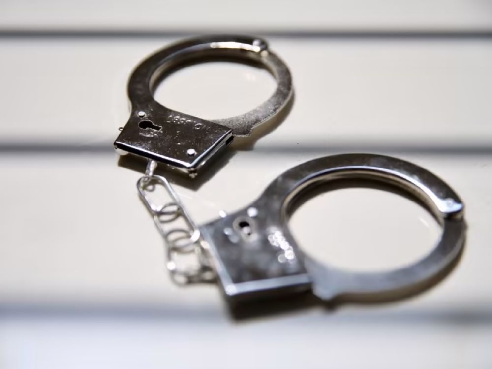 Activist Held for Investigation After Return from Thailand